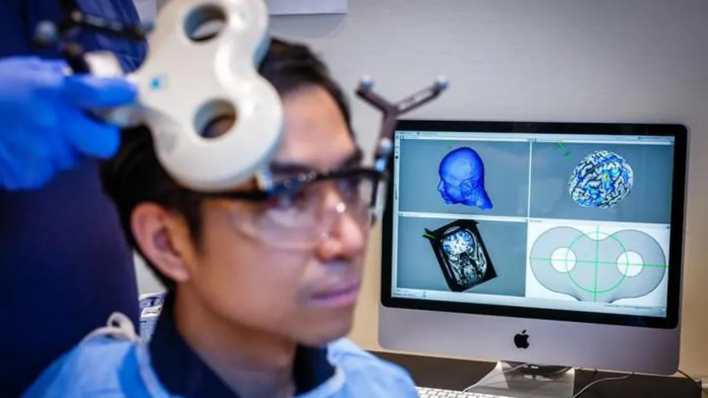 A participant receiving non-invasive brain stimulation during an experiment in a laboratory setting. The volunteer sits in the foreground with another person, whose hands can be seen, holding a scanning device over the person's head. A scan of their brain is visible on a screen behind. 
