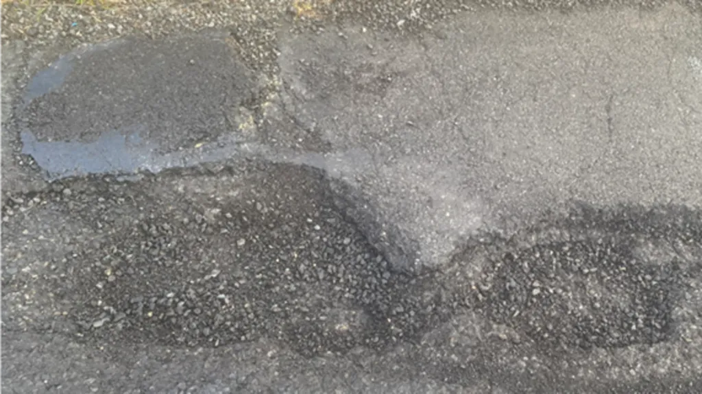A close up of a pothole