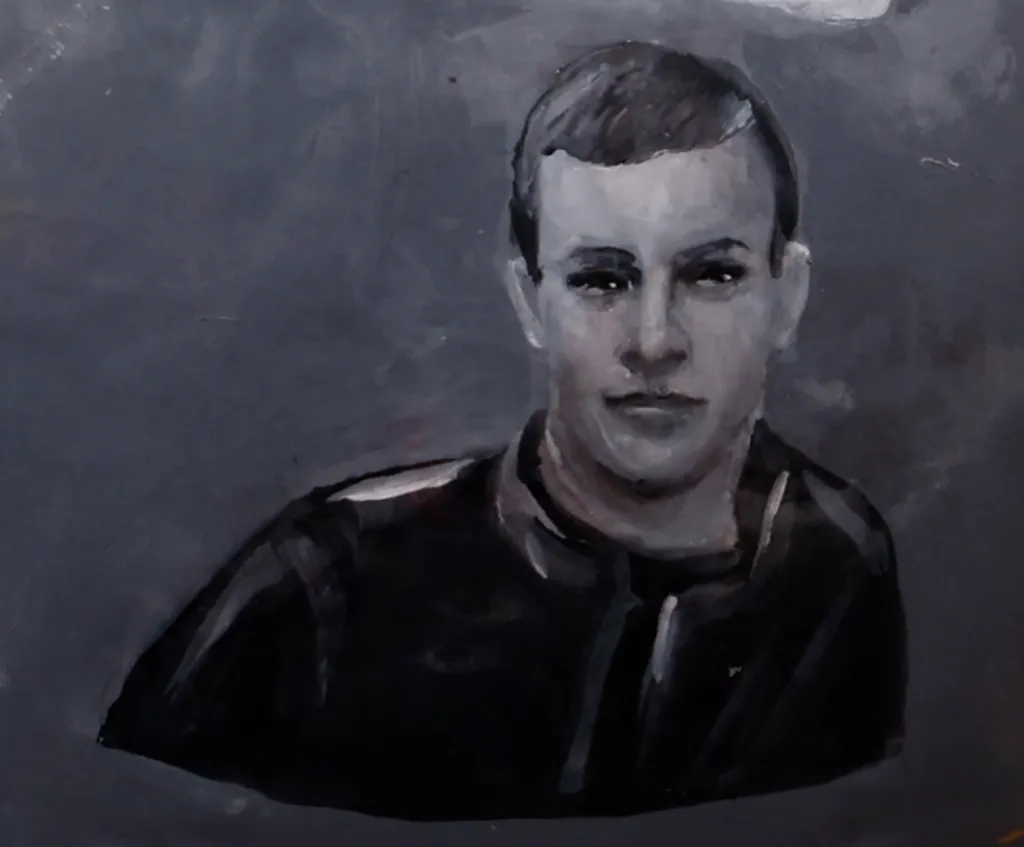 Close up of the helmet featuring an illustration of Volodymyr Androschuk, who has short hair and has a zip-up jacket on.
