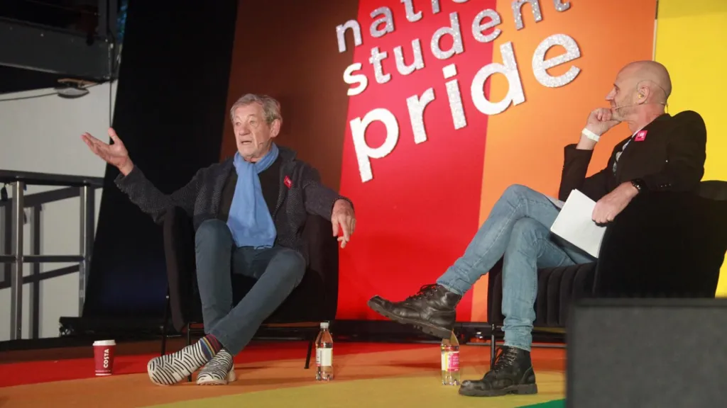 Sir Ian McKellen sits in an armchair opposite broadcaster Evan Davis, and speaks to the crowd