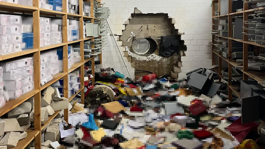 A wall in a bank with a mess on the floor