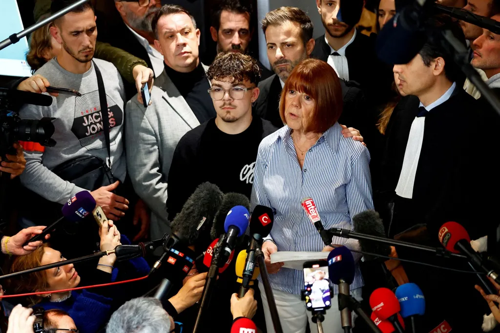 Gisèle Pelicot, the victim of a mass rape orchestrated by her then-husband Dominique Pelicot at their home in the southern French town of Mazan, talks to journalists after the verdict in the trial for Dominique Pelicot and 50 co-accused, at the courthouse in Avignon, France, December 19, 2024. Pelicot stands next to her son Florian as her other son David stands behind