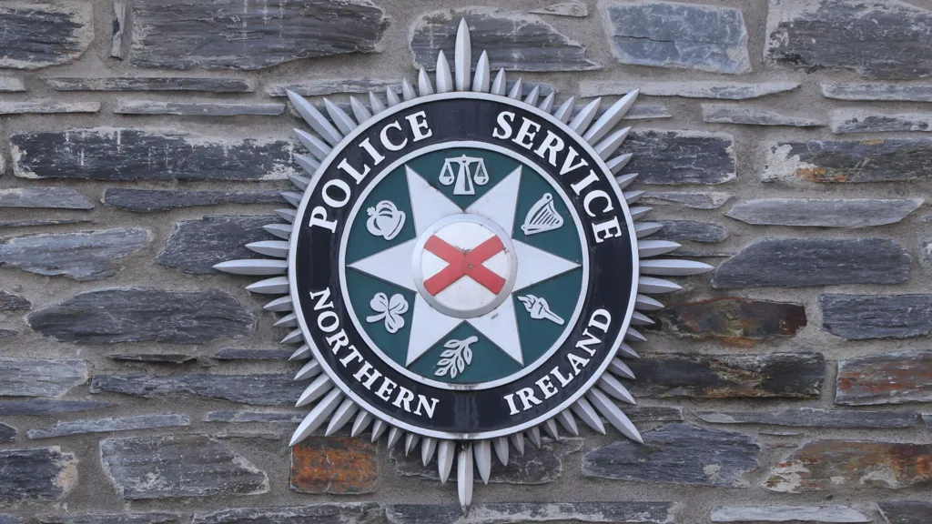 PSNI logo on a stone wall 