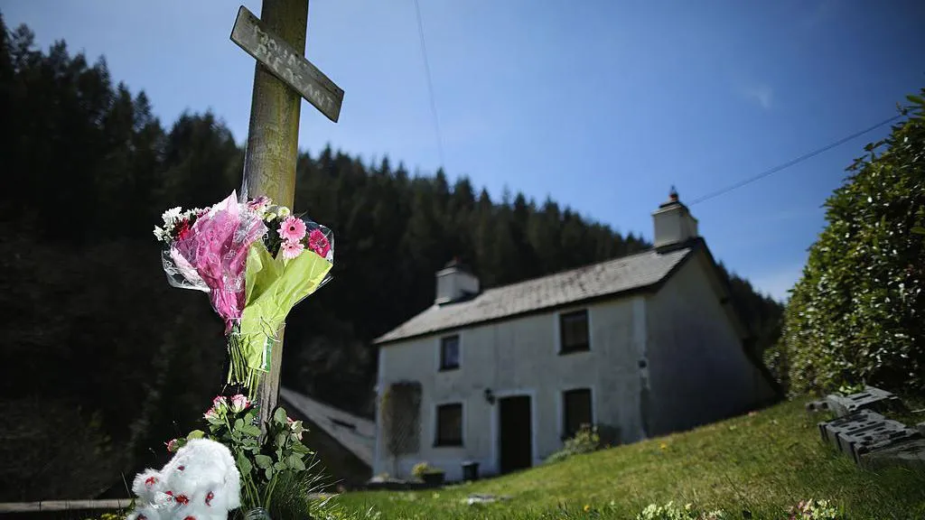 A teddybear and floral tributes adorn a post outside of the former home of Mark Bridger in Ceinws, Mid Wales who was convicted of the abduction and murder of April Jones in 2013 in Machynlleth, Wales. The jury trying Bridger visited key scenes in Machynlleth following the disappearance of five-year-old April Jones.