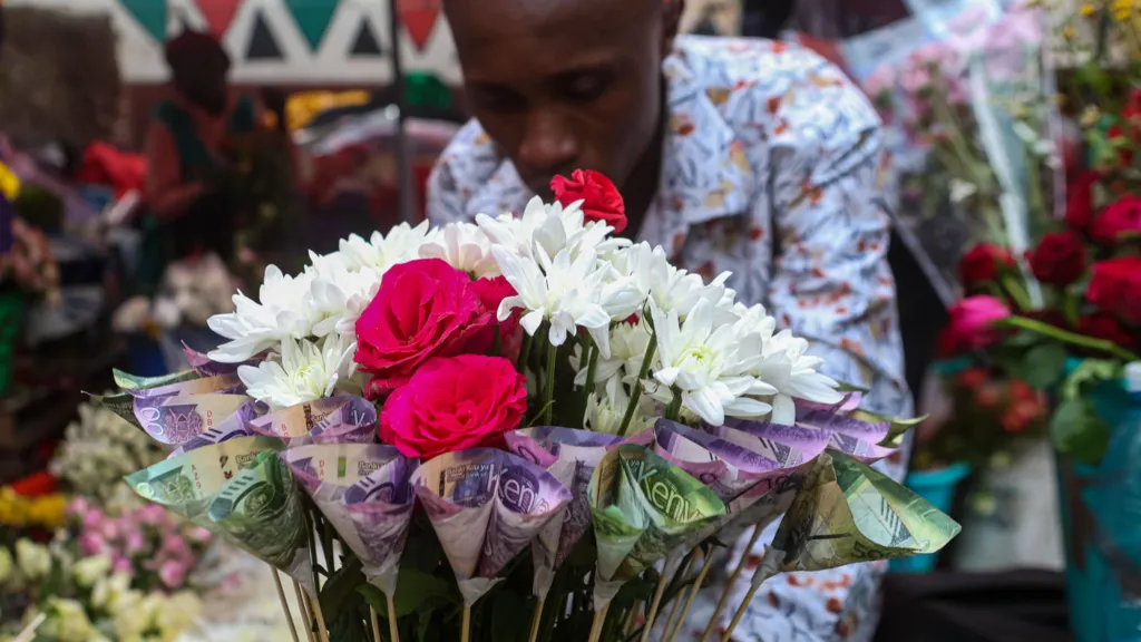 A Kenyan businessman prepares a money bouquet made up of Kenya shillings mixed with fresh flowers for a customer during Valentine's day