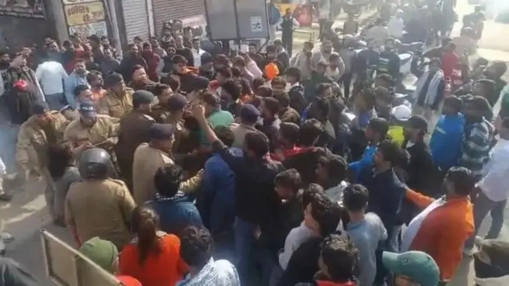 Protesters and police outside Deepak Kumar's gym in India's Kotdwar town